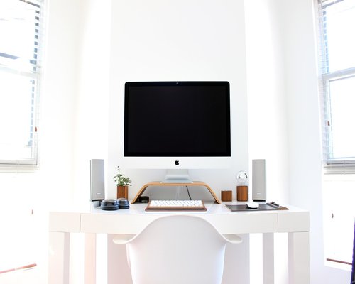 Detail of a minimalist workspace beside a window with gentle daylight