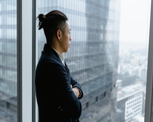 Person looking out a high-rise office window in Mexico City