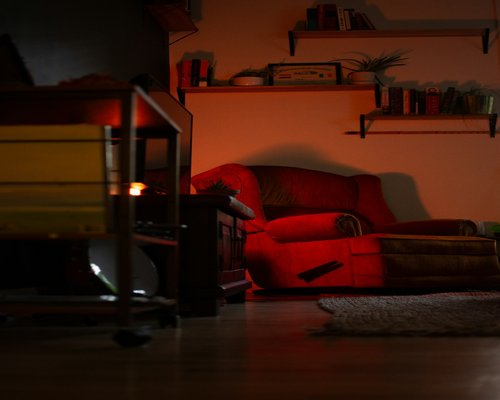 Person relaxing on an armchair with eyes closed in a softly lit room
